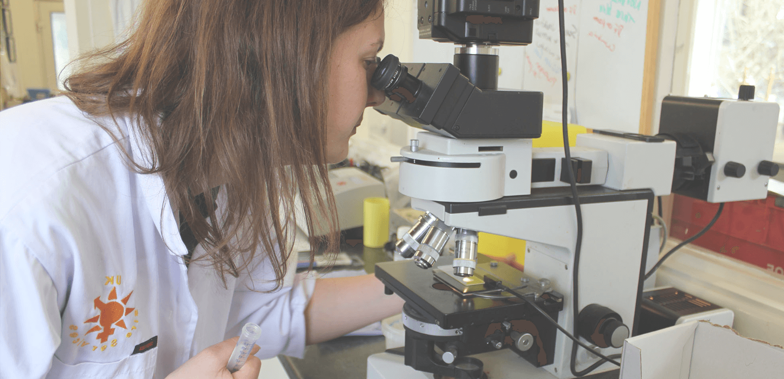 Women looking through microscope